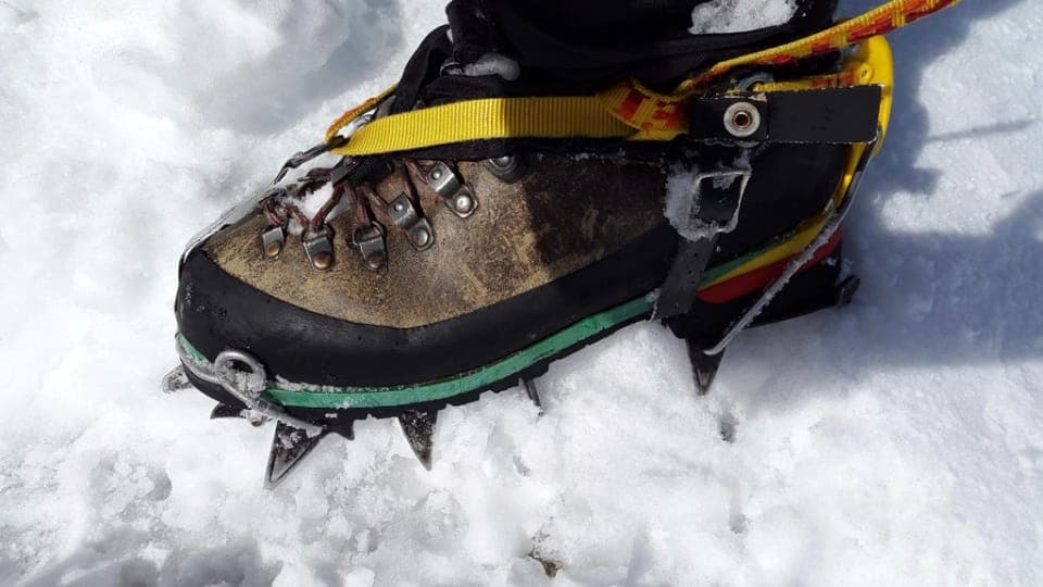 A cushioned zero-drop hiking sneaker on a gravel path